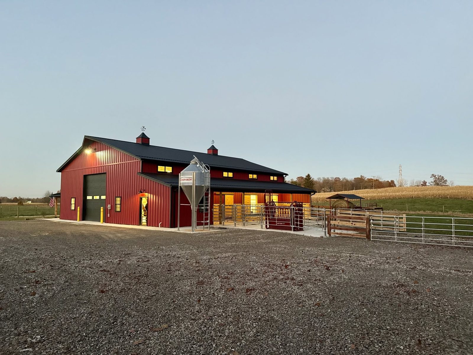 The Dzugan Farms barn at dusk with cattle handling pens